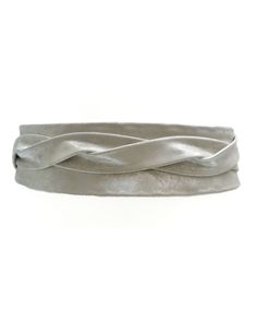 a close up of a silver headband on a white background