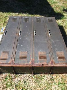 an old metal box sitting in the grass