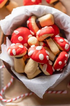 a bowl filled with cookies covered in red and white icing