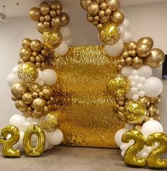 gold and white balloons in the shape of numbers