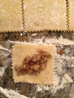 some food that is laying out on top of a table with powdered sugar and other items