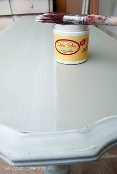 a paint can sitting on top of a white table