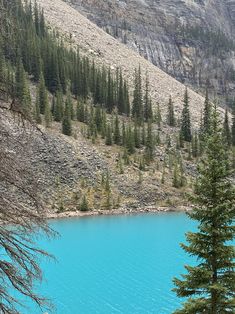 a blue lake surrounded by mountains and trees