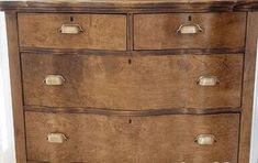 an old wooden dresser with drawers and knobs