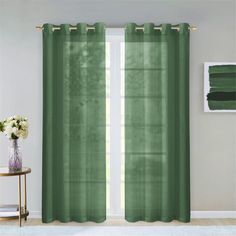 a green curtain hanging in front of a window