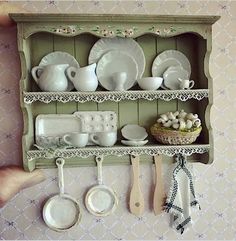 a shelf with dishes and utensils on it