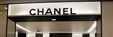 the entrance to a chanel store with black and white striped walls