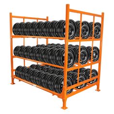 an orange rack filled with lots of black tires