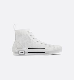 The B23 high-top sneaker is set apart by its layering of transparent paneling and white Dior Oblique canvas. Essential details, such as eyelets and a lace-up front, a white rubber sole, a rounded and reinforced toe as well as a rear tab recall the codes of the classic high-top style. The sneaker is further enhanced with contrasting details on the sides, including a Dior signature, and pairs easily with any casual outfit.. Dior Jordan 1's, Givenchy Jacket, Louboutin Bags, Off White Jacket, Dior Oblique, Set Apart, Hype Shoes, Newest Jordans, Dior Shoes