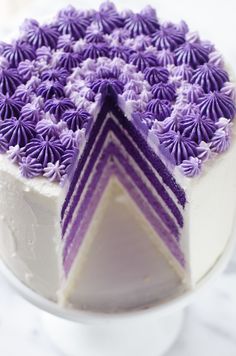 a white cake with purple frosting on top