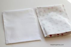 two folded napkins sitting on top of a white countertop next to each other