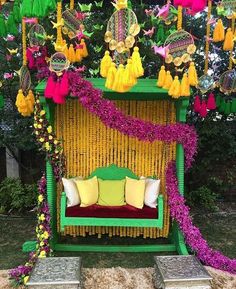 a green bench with yellow and pink decorations on it