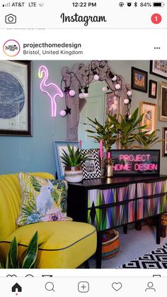 a living room filled with lots of furniture and pictures on the wall next to a yellow chair