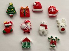 christmas decorations are arranged on a white surface