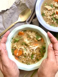 two bowls of chicken noodle soup on a table