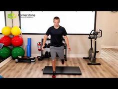 a man is running on a treadmill in a room with exercise balls and other equipment