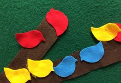 felt birds sitting on a branch with leaves