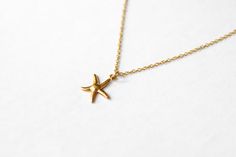 Starfish necklace - minimalist necklace with a gold tone stainless steel chain and gold tone stainless steel starfish pendant. Waterproof necklace. The necklace in the photo is 16 inches long (40.6 cm) with a clasp closure. If you would like a different length you can choose your option at checkout. ♥ Chain material: stainless steel (waterproof) ♥ Pendant material: stainless steel (waterproof) ♥ Chain length: 16 inches (40.6 cm). If you would like a different length you can choose your option fr Minimalist Starfish Charm Jewelry, Minimalist Starfish Jewelry Gift, Waterproof Necklace, 90s Choker, Charm Choker Necklace, Moon Bracelet, Black Choker Necklace, Starfish Pendant, Stainless Steel Chain Necklace