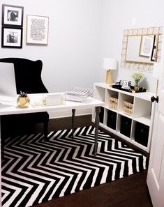 a black and white rug in front of a desk