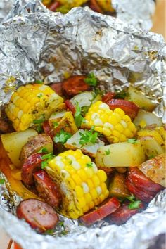 corn on the cob and sausage wrapped in foil