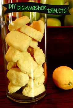 a glass filled with food sitting on top of a wooden table