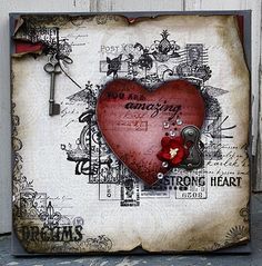 a red heart with an old key hanging from it's side on a piece of paper