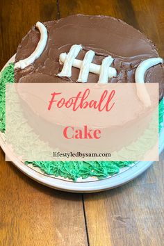 a football cake sitting on top of a wooden table with the words football cake over it