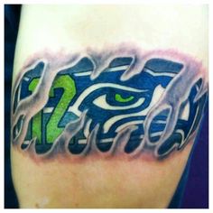 a close up of a person's arm with an eye and letters on it