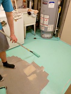 a man is using a mop to clean the floor