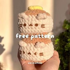 a person holding up two crocheted hello kitty cookies with the words free pattern on them