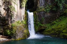 a waterfall in the middle of a canyon