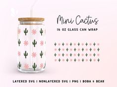 a glass jar with a straw and cactus pattern