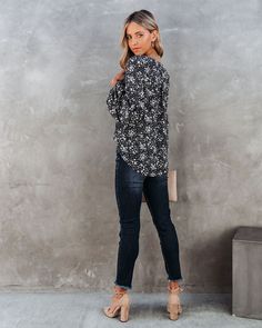 Relaxed Fit 100% Polyester Hand Wash Cold. Dry Flat Lace up Neckline Long Sleeves with Elastic Cuffs Lightweight Fabrication Not Lined A winter brunch blouse that's begging to be worn! Our Only In Your Dreams Floral Lace Up Blouse comes in a black base with white and pink delicate florals. The lace up necktie and long billowy sleeves make this the perfect daytime top. Styled with the Michaela Hoops. Lou Tag Necklace. Stella Crossbody Envelope Zip Clutch. Tilley Frayed Ankle High Waisted Skinny. and Ritz Faux Suede Pointed Heel.---SIZE AND FIT---Model is Wearing a Size Small. Height is 5'9". Bust is 32". Waist 24.5". and Hips 34" Size S: Length measures 24" from shoulder to hem with a 38" bust Size M: Length measures 25" from shoulder to hem with a 40" bust Size L: Length measures 25.5" fro Winter Floral Print V-neck Top, Chic Floral Print Tops, Chic Winter Floral Print Top, Black Long Sleeve Blouse For Brunch, Long Sleeve Black Blouse For Brunch, Winter Brunch, Lace Up Blouse, Women Floral Blouse, Crop Top Blouse