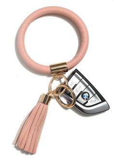 a cell phone keychain with a pink tassel hanging from it's side