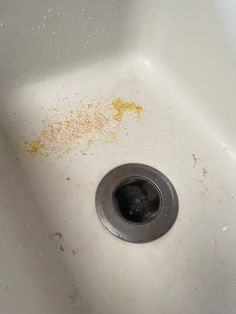 a dirty sink with rust on the bottom and yellow stains all over it's surface