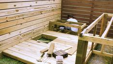 a man sitting on top of a wooden deck