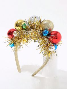 a close up of a headband with ornaments on the top and gold tinsel