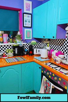 a kitchen with blue cabinets and black and white checkered walls