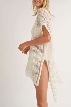 Add a playful touch to your beach look with the Hailee V Neck Knit Cover Up. This ivory-colored cover up features a deep v-neck and high side slits, making it both stylish and comfortable. With an oversized, relaxed fit and high-low hem, it's the perfect piece to throw on over your swimsuit for a day at the beach. Bohemian Knit Cover-up For Beach Season, Breezy V-neck Tops For Beach, White V-neck Breezy Cover-up, Lightweight V-neck Beach Cover-up, V-neck Beachwear Cover-up For Day Out, Beachy White V-neck Cover-up, Summer Beige Knit Cover-up, Spring Knit Cover-up For Warm Weather, Lightweight V-neck Cover-up For Beachwear