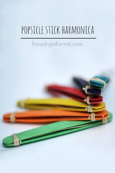 a stack of colorful umbrellas sitting on top of each other next to the words popsicle stick harmonica