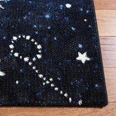 a black rug with white stars on it