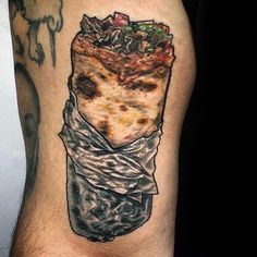 a man's leg with a piece of pizza on it