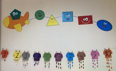 a bulletin board with clothes hanging from it's sides and numbers on the line