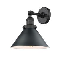 an industrial style wall light with a black shade