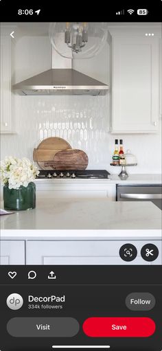 a kitchen with white cabinets and an appliance on the phone showing what's cooking