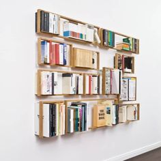 the bookshelf is made out of wood and has many different types of books on it