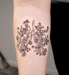 a tattoo on the leg of a woman with flowers