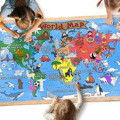 two children are playing with a map of the world