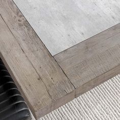 a close up of a wooden table with white carpet