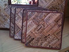 three framed cork art pieces sitting on top of a wooden table